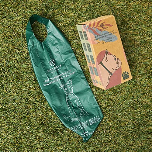 Biodegradable dog poop bag and packaging on grass.